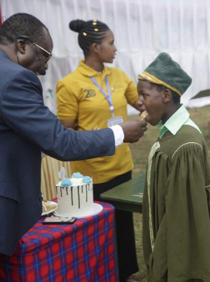 Anita receiving Cake on her graduation